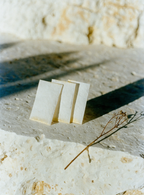 Fragrance blotter strips on a limestone ledge — sample on skin before committing to a full bottle